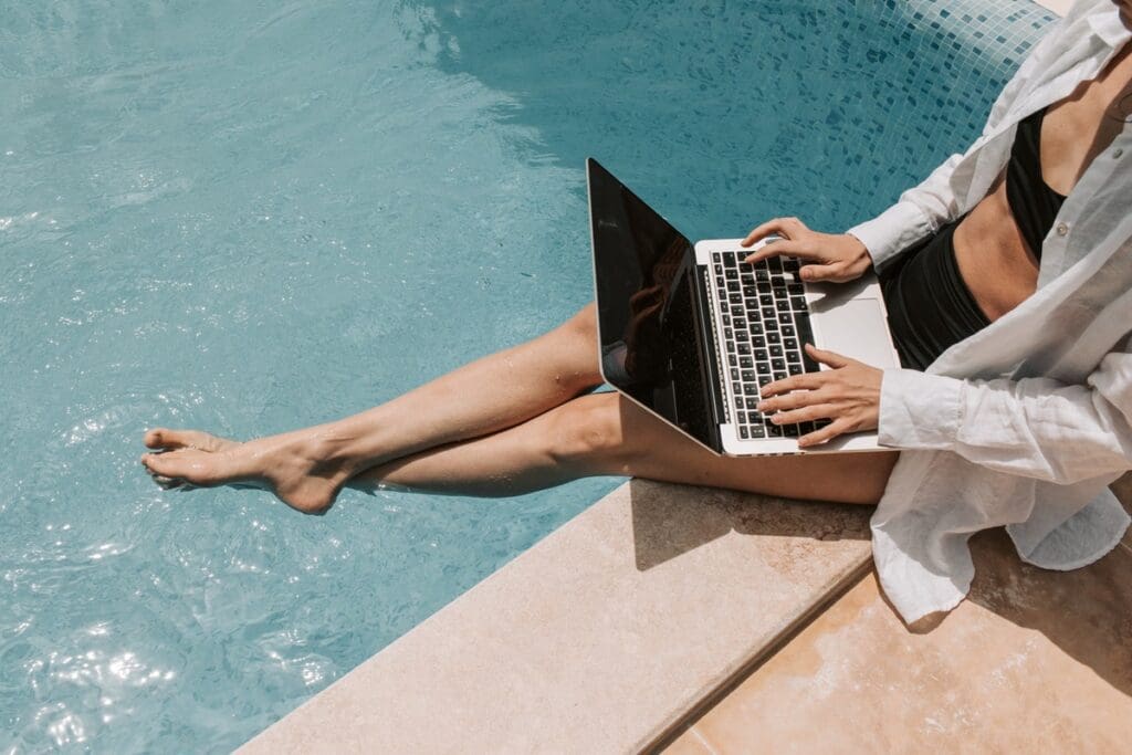 using laptop on pool side 