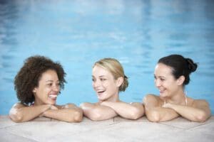 three women talking in the pool